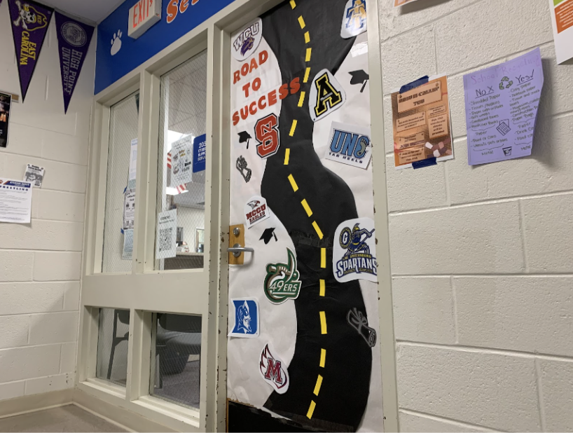 A college road design is featured on the door of the student services office. The staff hopes to encourage students to apply to colleges all over the state.
